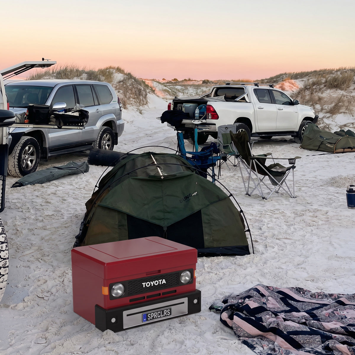 70 Series Red ute mini cooler on the sand at a beach dune camp at dusk